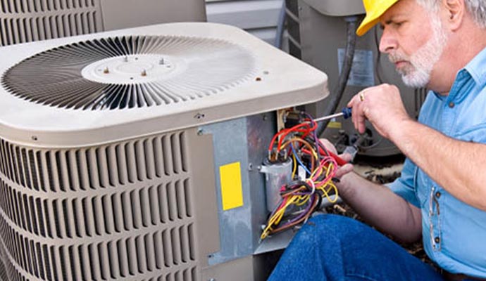 Expert repairing the air conditioner with equipment