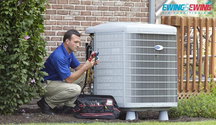 Technician replacing an old heat pump system