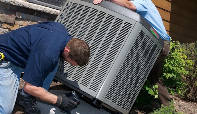 Person installing an outdoor HVAC unit