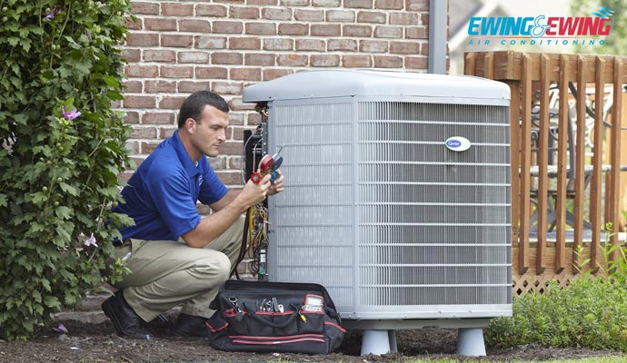 A person maintains an AC unit