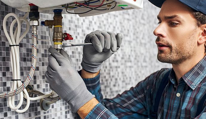Technician providing emergency heating service using professional tools